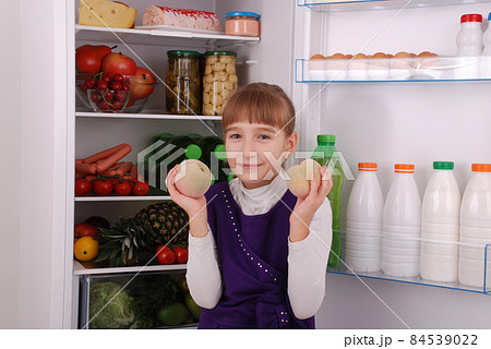 Beautiful girl near the Fridge with healthy food. Beautiful girl near the Fridge with healthy food. 84539022