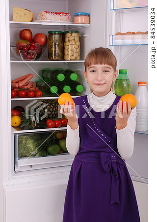 Beautiful  girl near the Fridge with healthy food. 84539034