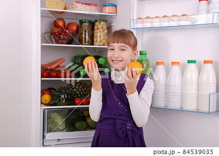 Beautiful  girl near the Fridge with healthy food. 84539035