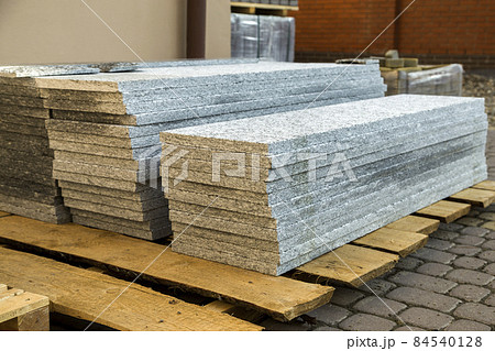 Piles of granite marble slabs. Stone sheets for decorative construction. 84540128