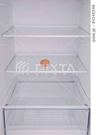 One eggs in open empty refrigerator. One eggs in open empty refrigerator. 84540598