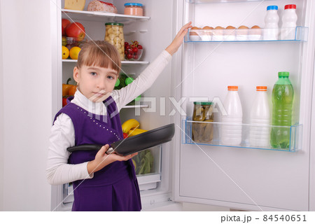 Beautiful girl near the Fridge with healthy food. Beautiful girl near the Fridge with healthy food. 84540651