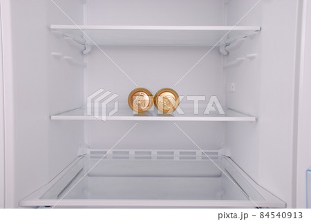 Two metal beer cans inside in empty clean refrigerator 84540913