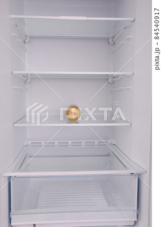 One metal beer cans inside in empty clean refrigerator 84540917