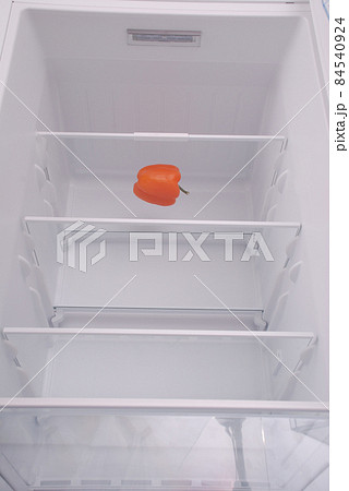 One pepper in open empty refrigerator. 84540924