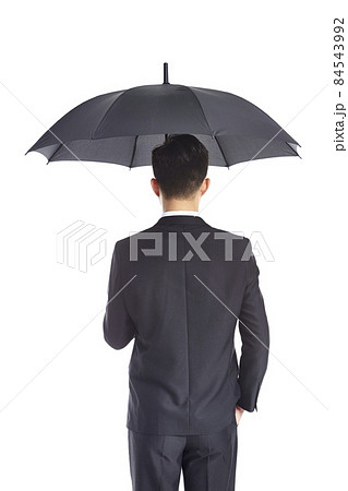 asian businessman holding umbrella 84543992