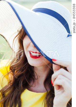 portrait of a beautiful woman in a hat with brimming on a walk portrait of a beautiful woman in a hat with brimming on a walk 84553308