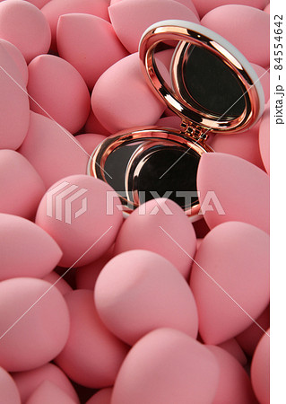 beauty background a bunch of pink gentle makeup sponges and a mirror vertical orientation beauty background a bunch of pink gentle makeup sponges and a mirror vertical orientation 84554642