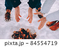 Man and woman warm their hands near fire. winter theme 84554719