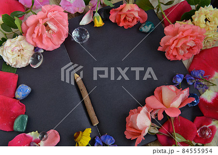 Still life with open diary with black pages, flowers, crystals and copy space, top view. Esoteric, gothic and occult background, Halloween mystic concept. Still life with open diary with black pages, flowers, crystals and copy space, top view. Esoteric, gothic and occult background, Halloween mystic concept. 84555954