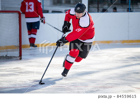 Professional ice hockey player in attack on the rink 84559615