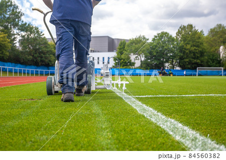 marking the boundaries of the football stadium in white 84560382