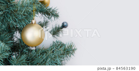Christmas banner with christmas tree garland and ornaments. New Year background. Hanging gold balls and ribbons. Horizontal Christmas header for website template, flyers and posters. Flat top view. Christmas banner with christmas tree garland and ornaments. New Year background. Hanging gold balls and ribbons. Horizontal Christmas header for website template, flyers and posters. Flat top view. 84563190