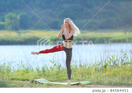 Young beautiful woman squats shows result press on stomach workout training wearing top Young beautiful woman squats shows result press on stomach workout training wearing top 84564451