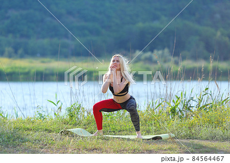 Young beautiful woman shows press stomach workout training wearing top. 84564467