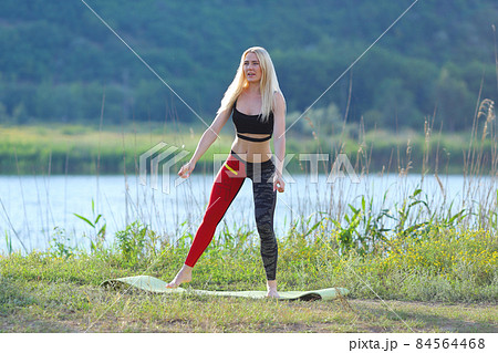 Young beautiful woman squats shows result press on stomach workout training wearing top 84564468