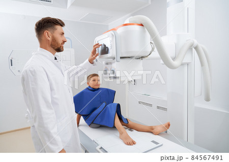 Teenager boy lie down in hospital on ultrasound diagnostic. 84567491