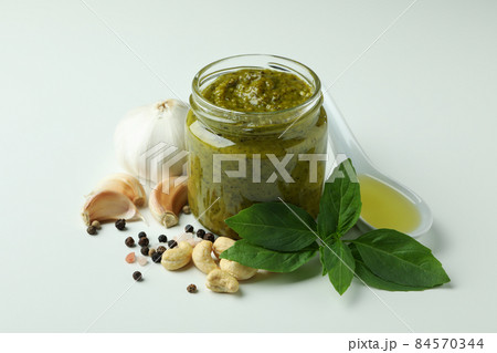 Pesto sauce and ingredients on white background Pesto sauce and ingredients on white background 84570344