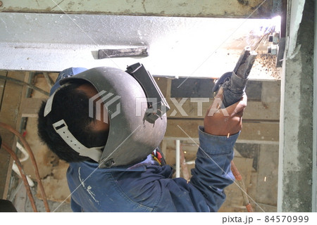 SELANGOR, MALAYSIA -DECEMBER 09, 2015: Welder wearing protective mask welding metal at the construction site.  84570999