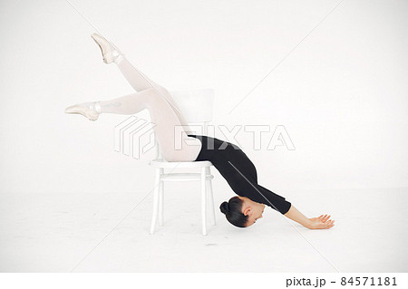 Ballerina posing in front of white background 84571181