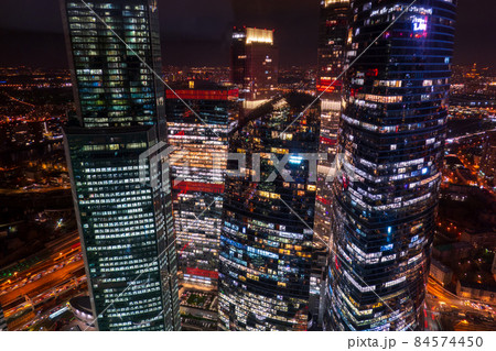 Illuminated skyscrapers in night city 84574450