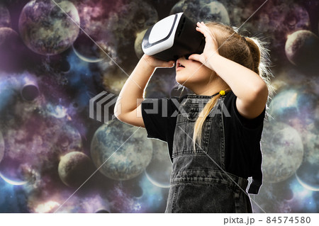 Cute teenage girl using VR glasses on colorful background with blank space for text 84574580