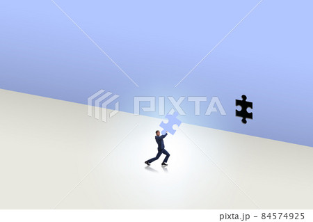 Businessman putting missing jigsaw puzzle piece Businessman putting missing jigsaw puzzle piece 84574925
