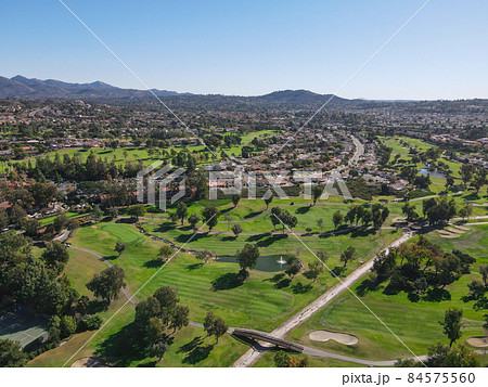 Aerial view of golf in residential neighborhood in an Diego County 84575560
