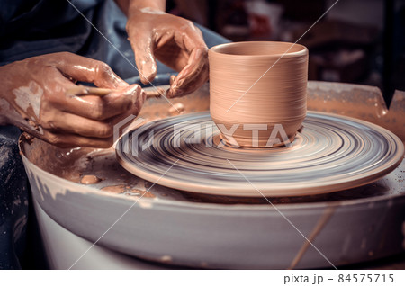 Potter craftsman working with pottery at the ceramic workshop. Inspiration and creativity. Close-up. Potter craftsman working with pottery at the ceramic workshop. Inspiration and creativity. Close-up. 84575715