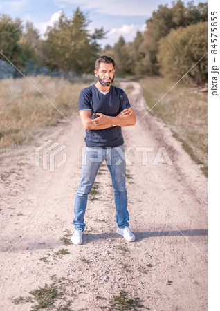 Modern vape man enjoying electronic cigarette in the calm outdoors. Hybrid cigarette. Modern vape man enjoying electronic cigarette in the calm outdoors. Hybrid cigarette. 84575855
