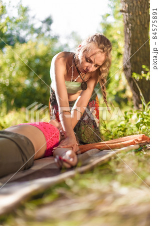 Massage professional impliments her massage abilities outside. Massage professional impliments her massage abilities outside. 84575891