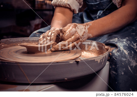 Craftsmen sculpts from clay. Craft manufacture. Close-up. 84576024