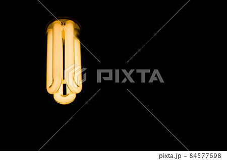Luminous tubes of a fluorescent lamp on a black background. Selective focus, copy space 84577698