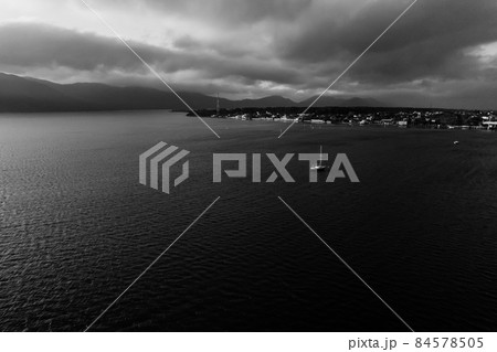 Yacht heading ashore. Dramatic black and white photo. Yacht heading ashore. Dramatic black and white photo. 84578505