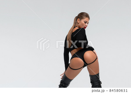 Alluring young woman in black underwear and boots Alluring young woman in black underwear and boots 84580631