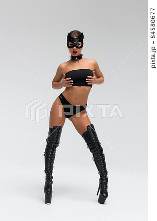 Seductive brunette in BDSM costume 84580677