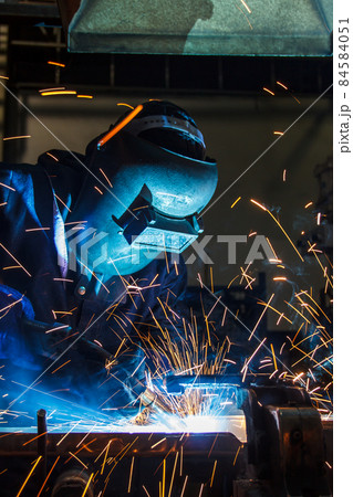 worker with protective mask welding metal 84584051