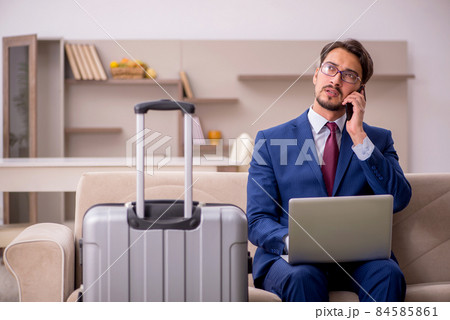 Young businessman preparing for trip at home Young businessman preparing for trip at home 84585861