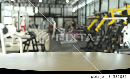 Wooden empty table on blurred background of fitness gym. Copy space for display of product. Wooden empty table on blurred background of fitness gym. Copy space for display of product. 84585885