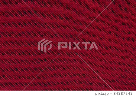 Red burlap background. Rough tissue structure. Texture 84587245