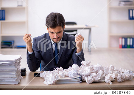 Young male employee in brainstorming concept 84587346