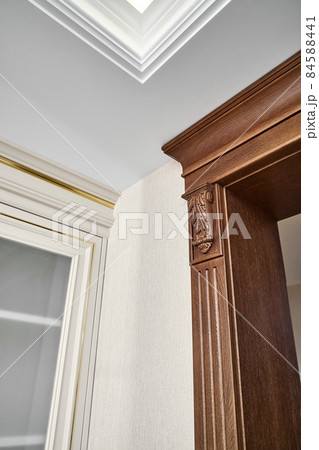 Wooden doorway near vintage display with glass door in light room 84588441