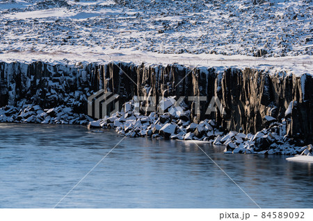 Boulder cubes under the cliffs with snow 84589092