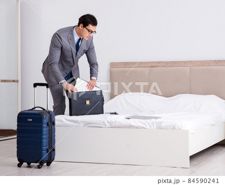 Businessman working in hotel room 84590241