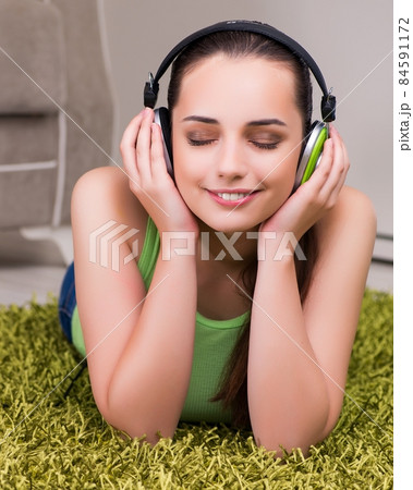 Young woman listening to music at home 84591172
