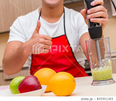 Handsome man working at the kitchen Handsome man working at the kitchen 84591183