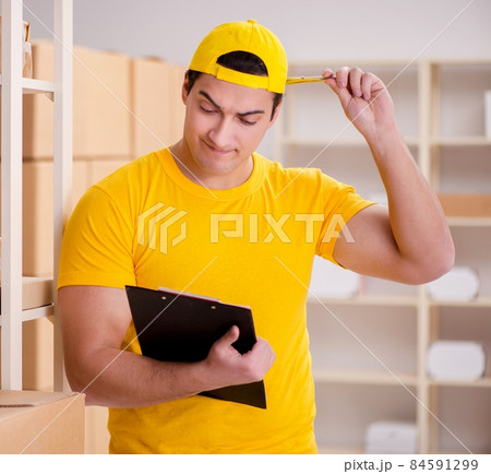 Man working in postal parcel delivery service office 84591299