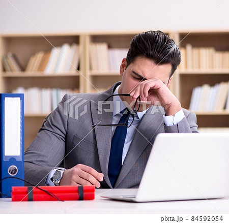 Businessman with dynamite in the office 84592054