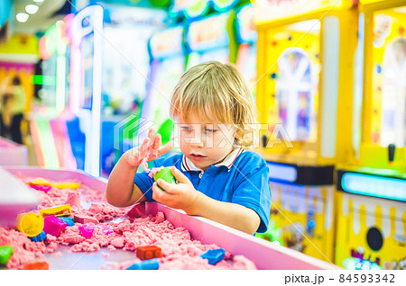 Boy playing with kinetic sand in preschool. The development of fine motor concept. Creativity Game concept Boy playing with kinetic sand in preschool. The development of fine motor concept. Creativity Game concept 84593342