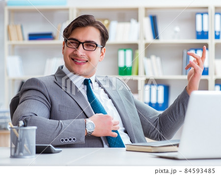 Businessman playing virtual guitar in office Businessman playing virtual guitar in office 84593485